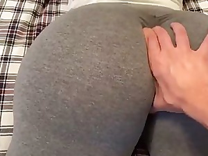 Huge donk brown-haired in yoga pants is giving a voluptuous foot wank to one of her homies